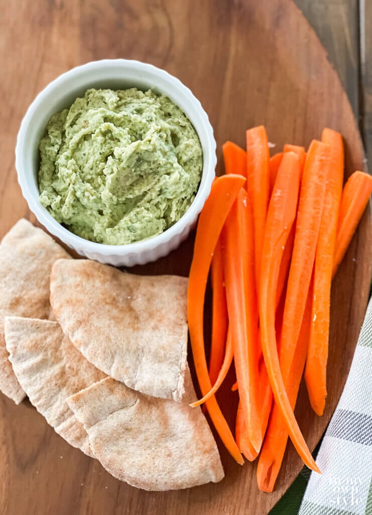 No oil Thyme and Basil No oil hummus served with carrot sticks and pita bread.