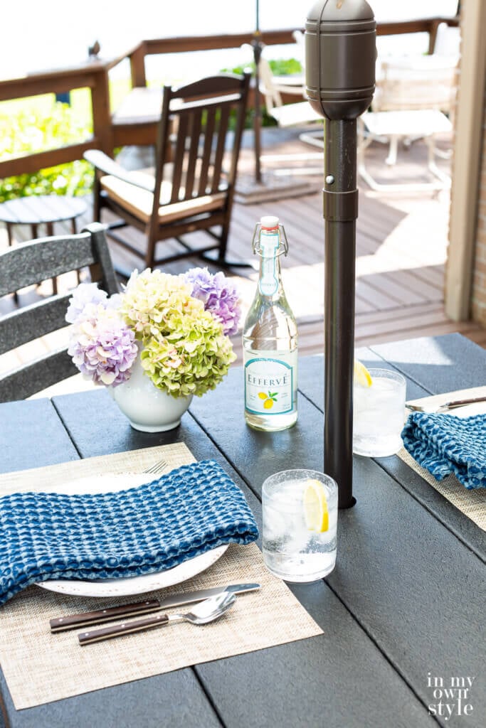 Black Bar height POLYWOOD outdoor bar set table on a deck set for dining.