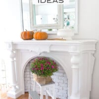 How to decorate using two mirrors and a collection of pumpkins over a mantel to create a warm and inviting look when decorating your home for fall.
