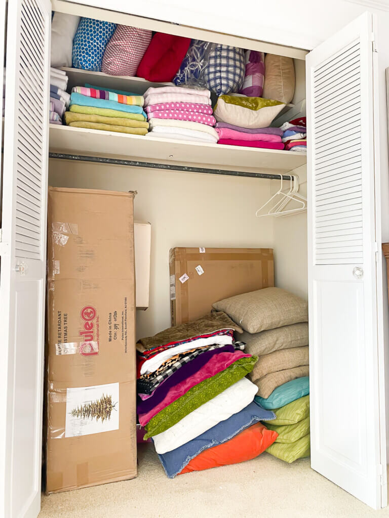 Clothes closet turned into a throw pillow storage closet.