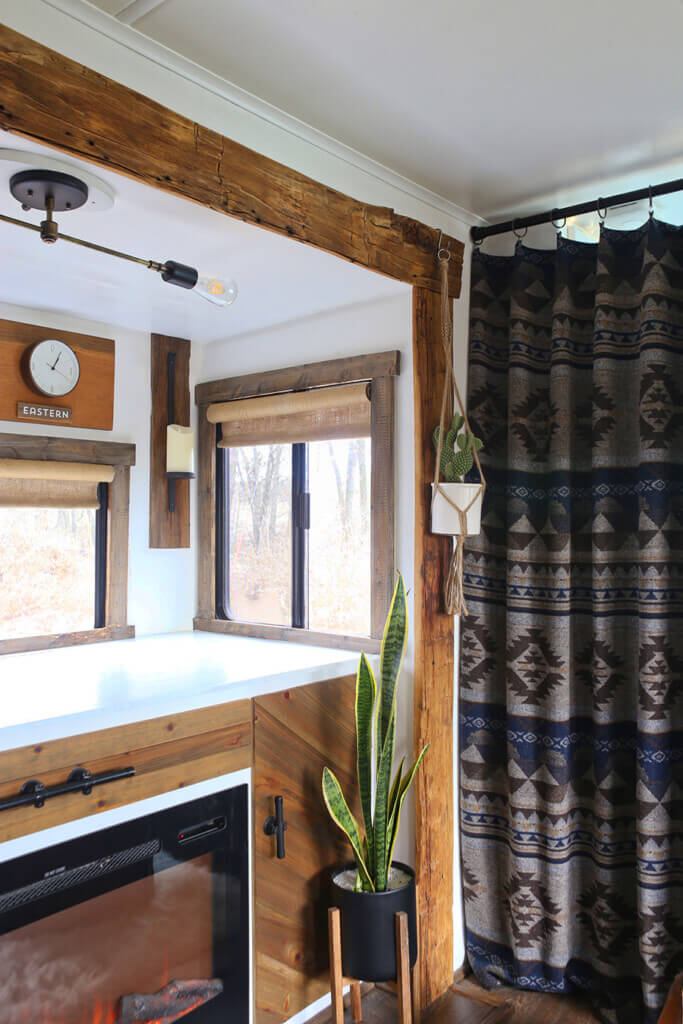A travel trailer interior makeover with no sew burlap roller shades at a window. 
