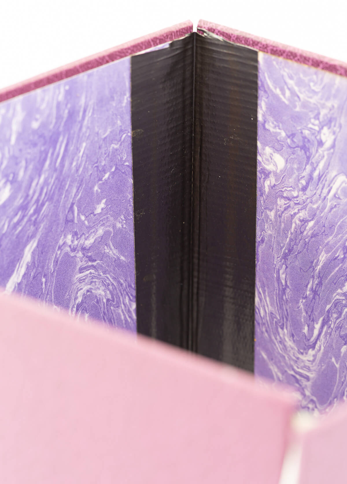 Inside book cover with duct tape to make into a pretty cover for a plant in an ugly planter pot.