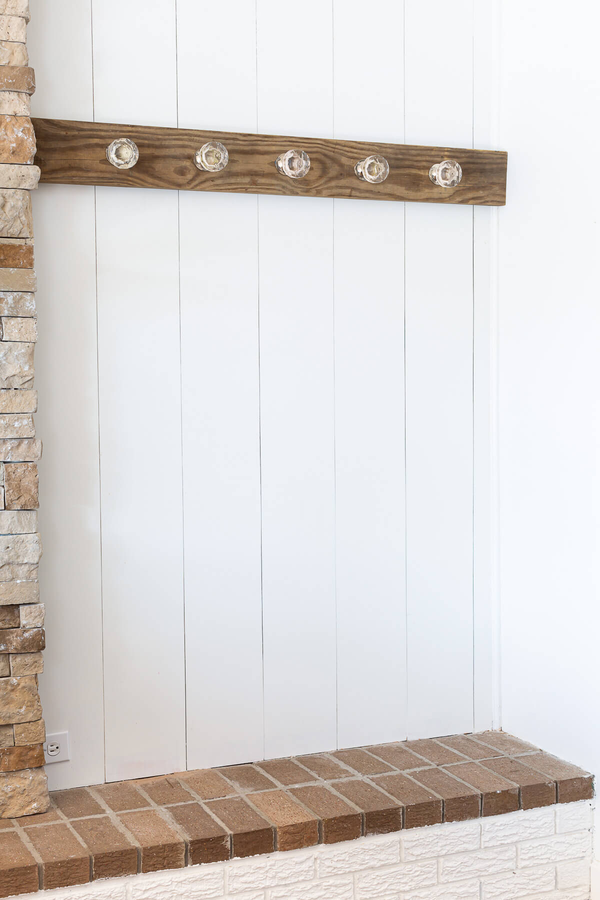 Blanket display idea made by mounting a board on a wall and attaching glass door knobs to decoratively hang blankets and quilts.