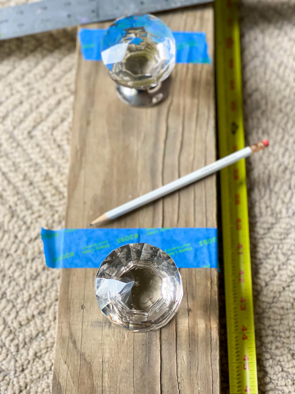 How to center doorknobs for blanket rack on wood board.