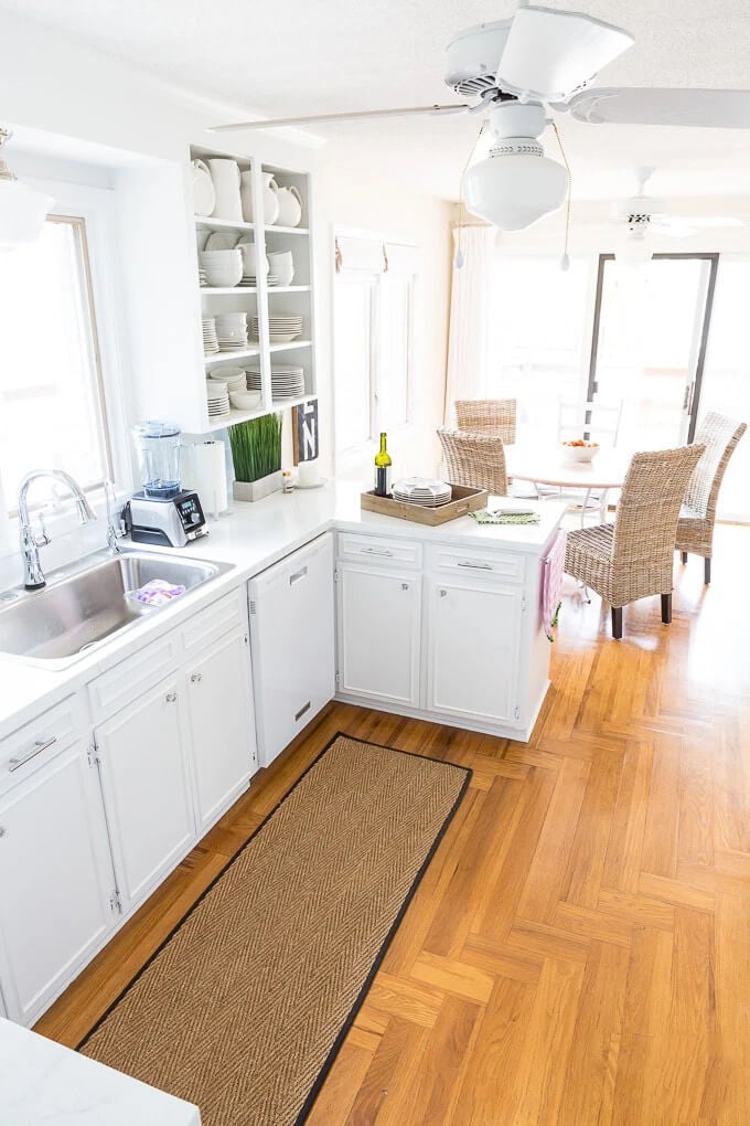 A small kitchen with DIY painted counters and Open shelf upper cabinet created by removing kitchen cabinet doors.