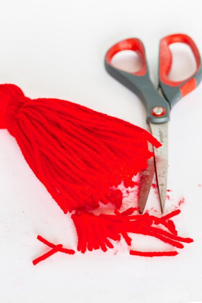 Cutting bottom with scissors to trim