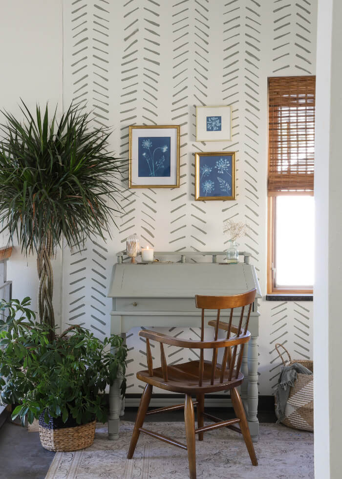 light green painted desk against an accent wall made using paint strokes