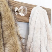 Repurpose doorknobs in creative ways. Make a wall-mounted holder using doorknobs as hooks.