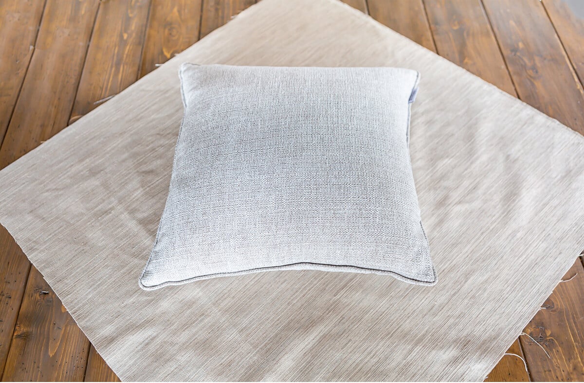 Pillow insert on a square of fabric.
