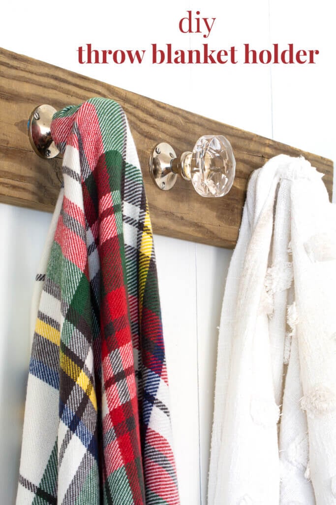 blanket display ideas - wood holder on wall using doorknobs as hooks.
