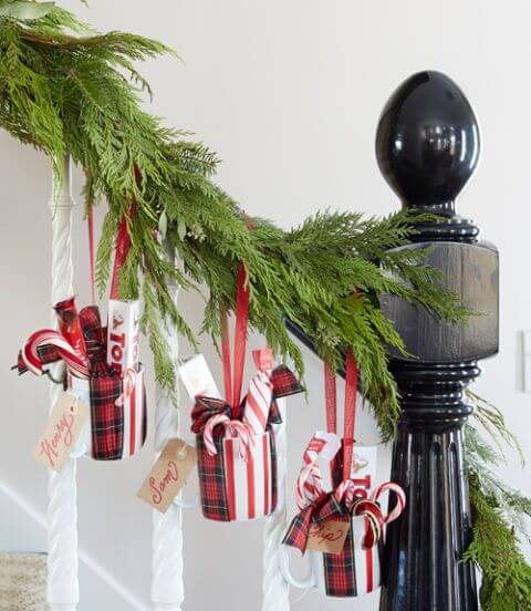 Christmas gifts festively tied to a staircase banister.