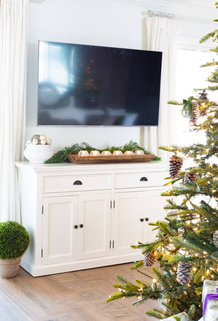 TV and console cabinet decorated for Christmas