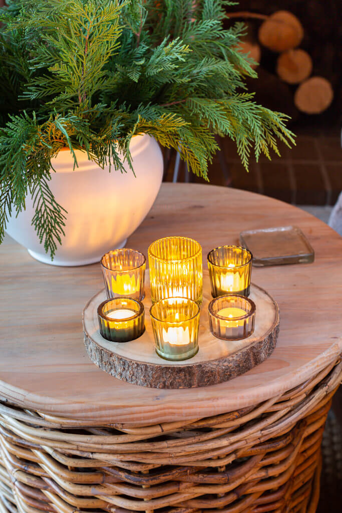 Christmas candles on round wood wicker basket table