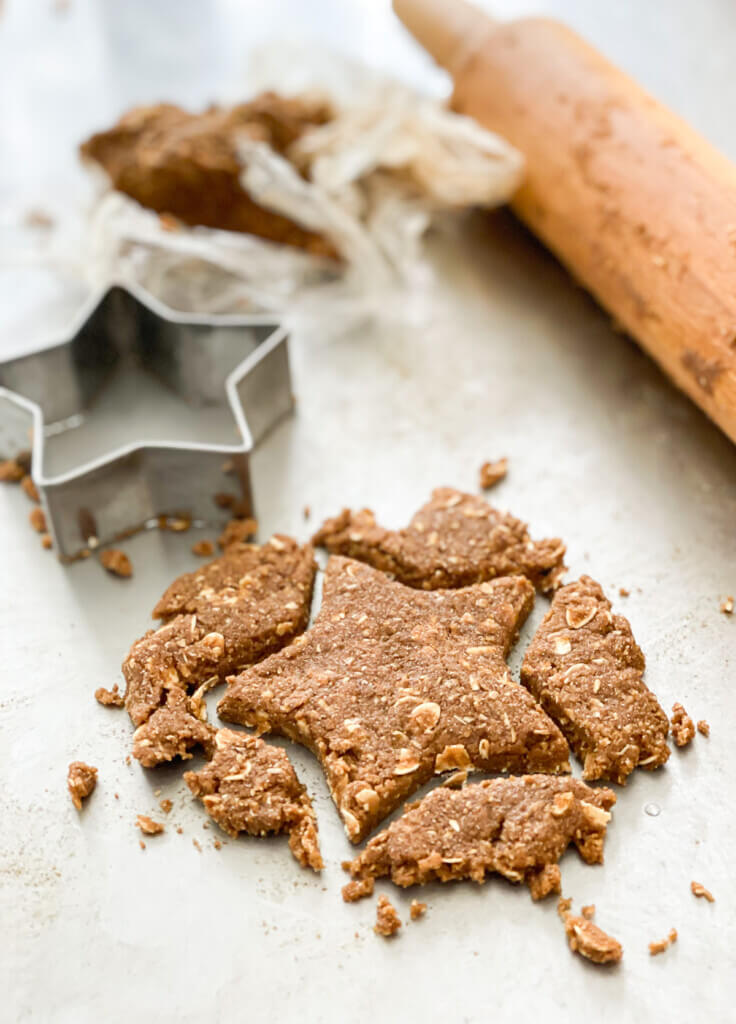 Rolled out dough cut out into a star shape with a cookie cutter.