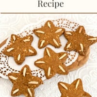 Star shaped vegan gingerbread cookies on a doily covered cutting board. Text overlay says Gingerbread cookies recipe.
