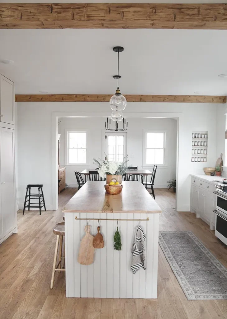a white kitchen makeover with rustic beams