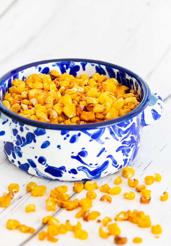 roasted corn in a blue and white ramekin is a sweet crunchy healthy snack that is easy to make.