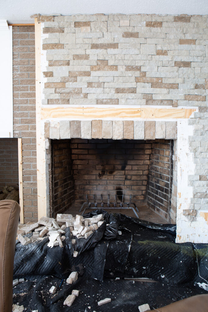 Stone surround around fireplace being removed