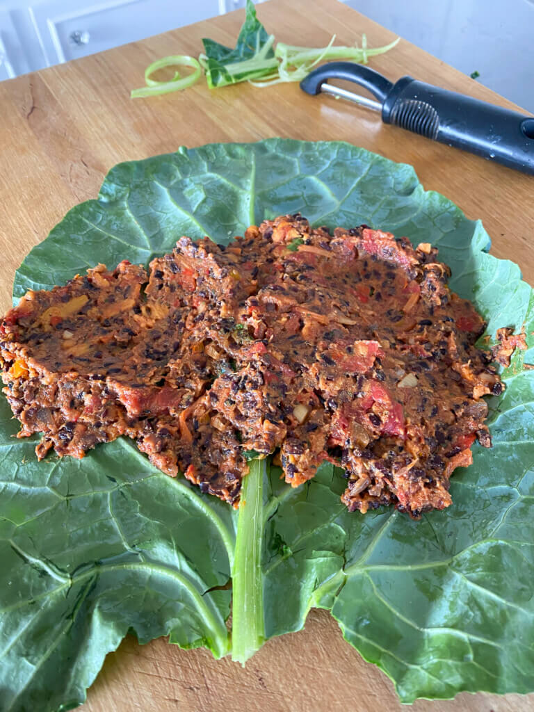 collard green wrap being made using a vegan filling