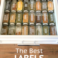 glass spice jars with labels in a drawer