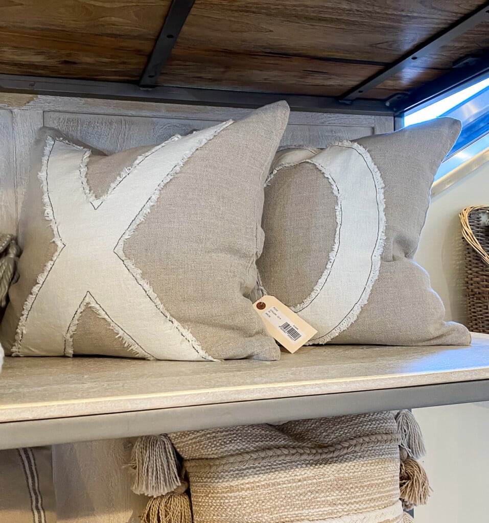xo pillows on shelf at a furniture store