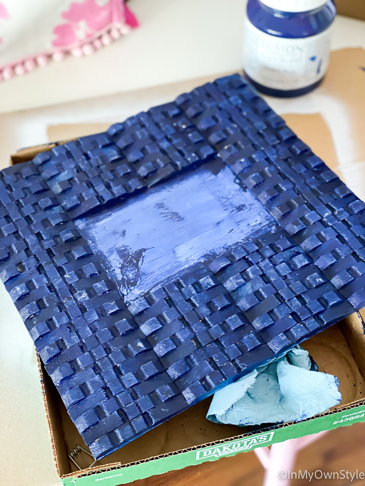 clothespin frame being painted blue