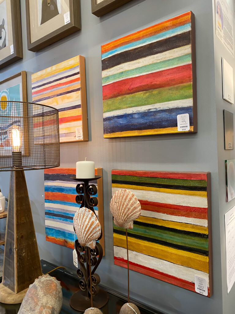 Easy knock off decor to do. Colorful painted stripe canvases on a wall.