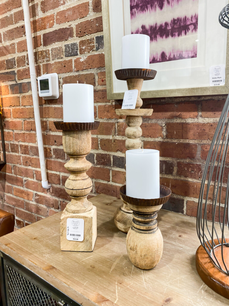 knock-off wood turned wood post pillar candle holders on a table.