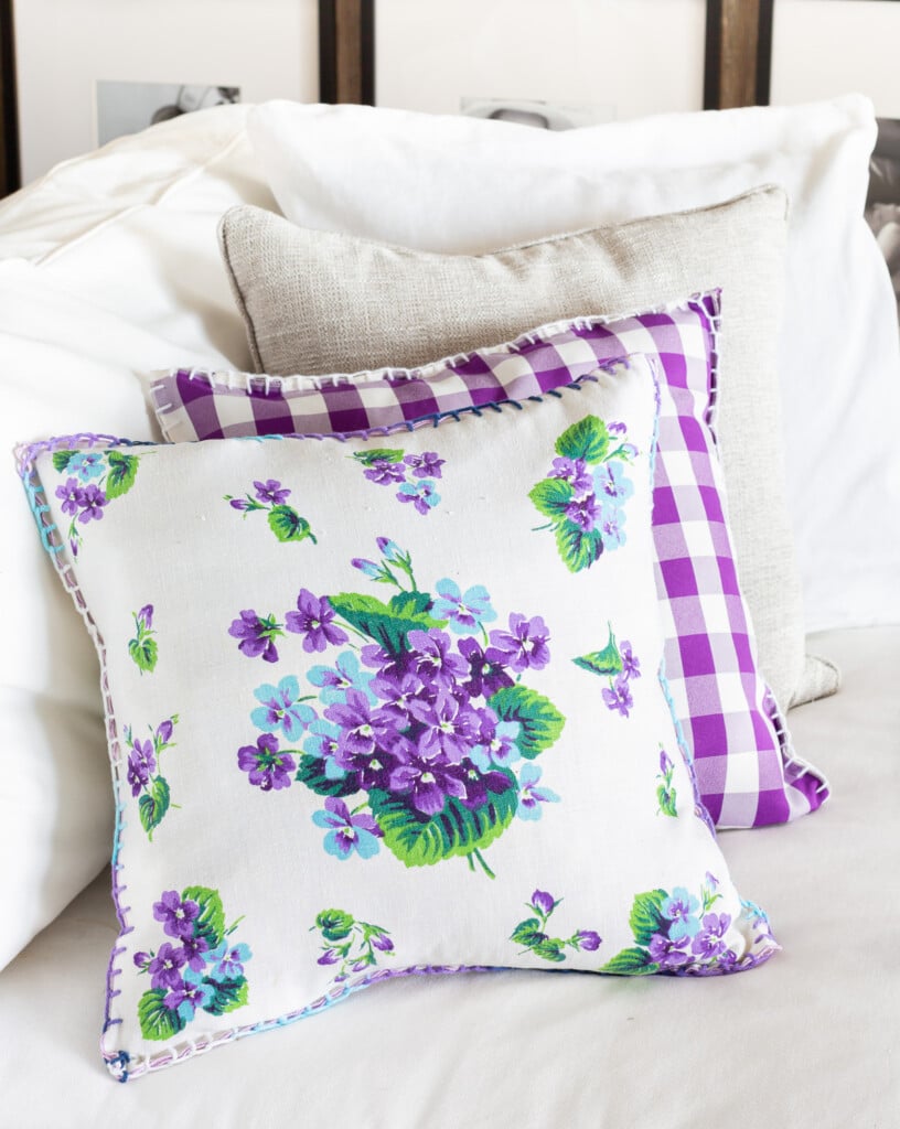 Repurposed old cloth napkins being used as pillow covers on a sofa.