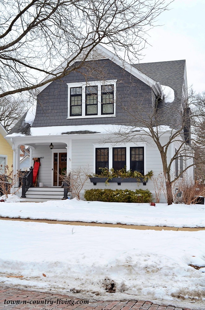 grey and white charming home in the snow