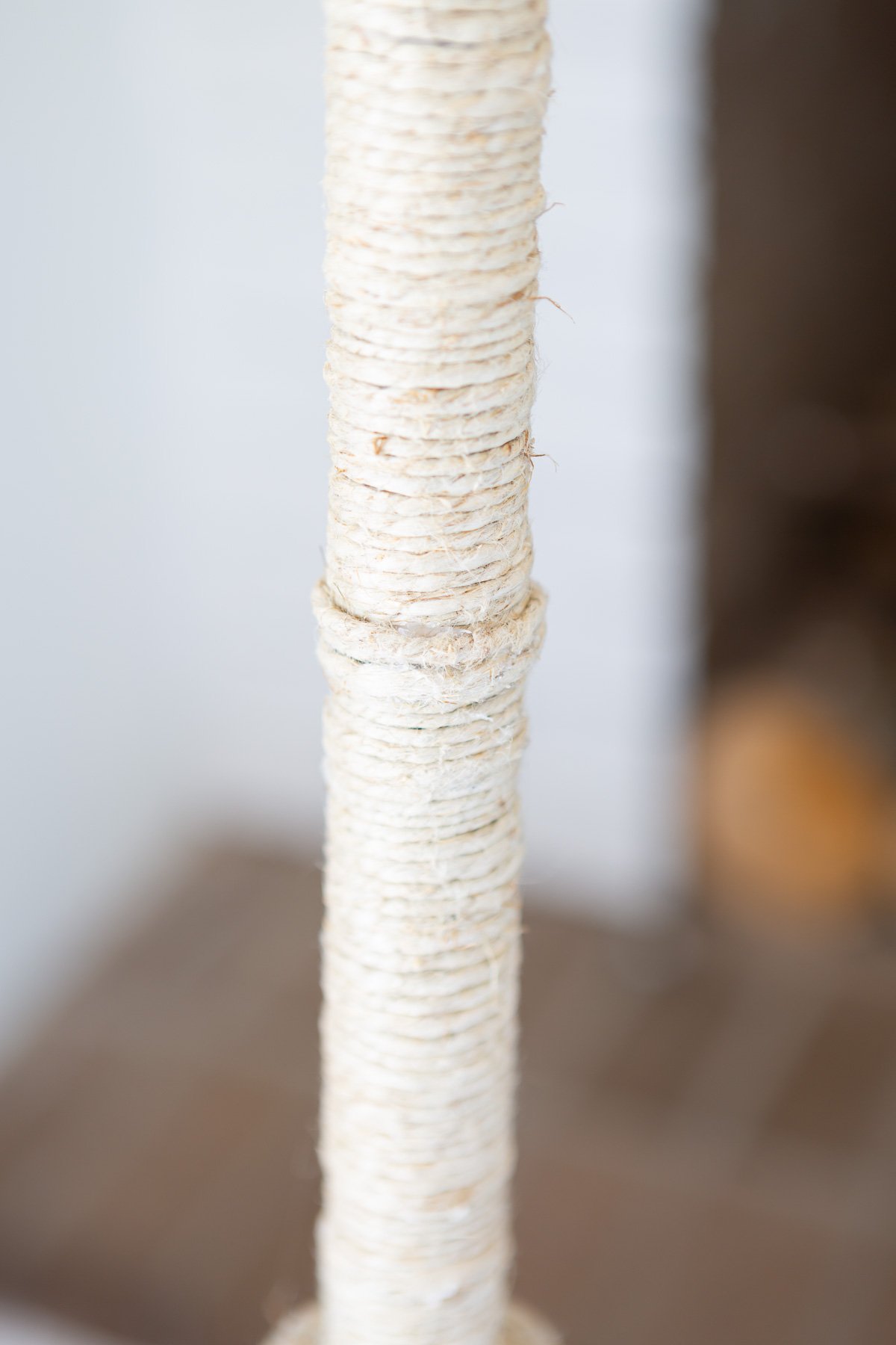 close up of polished hemp cord wrapped floor lamp pole.