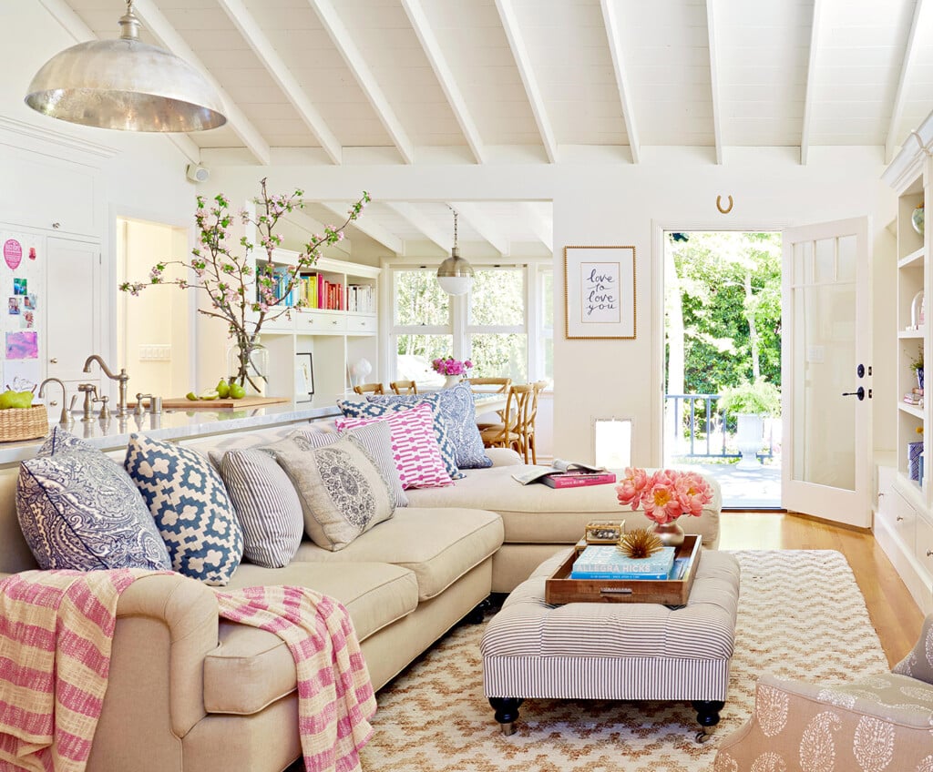 Bright white and colorfully decorated living room.
