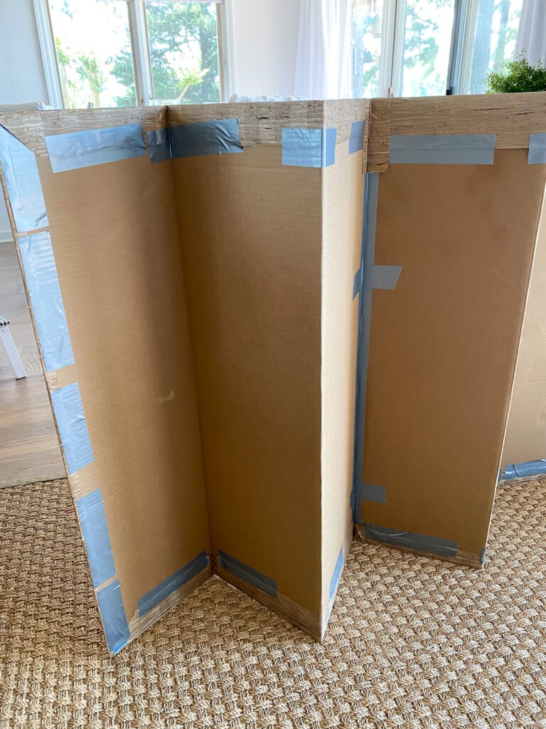 How to attach wallpaper to cardboard fireplace cover for summer.
