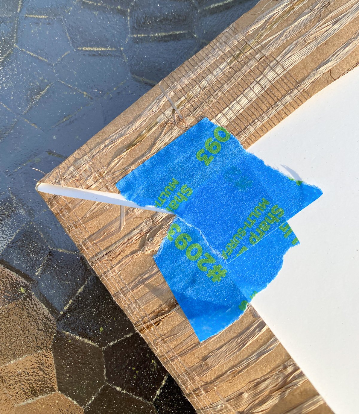 grasscloth taped around corner of photo frame mat.
