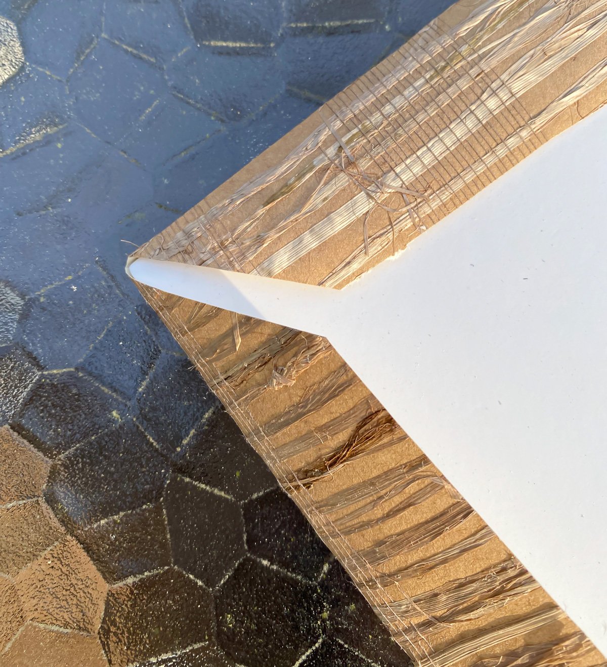 grasscloth wrapped around corner of photo frame mat.