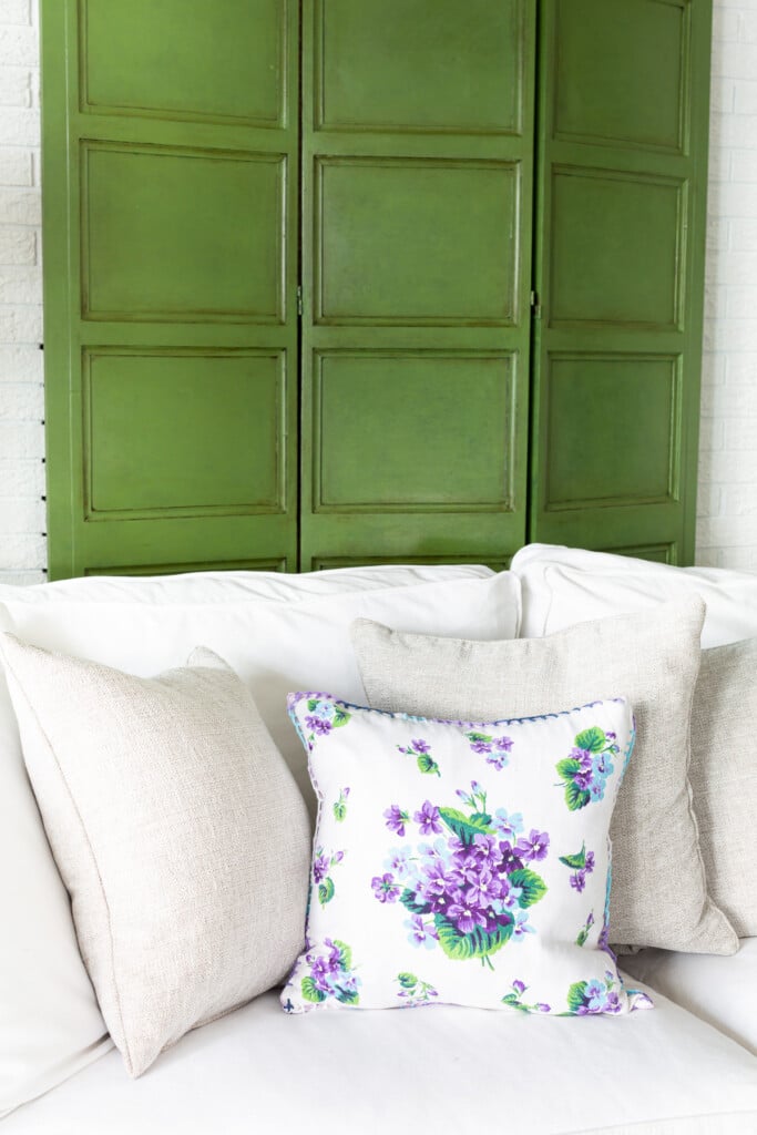 Antique Furniture With Glaze - decorative wood screen painted and glazed green. Behind a sofa.
