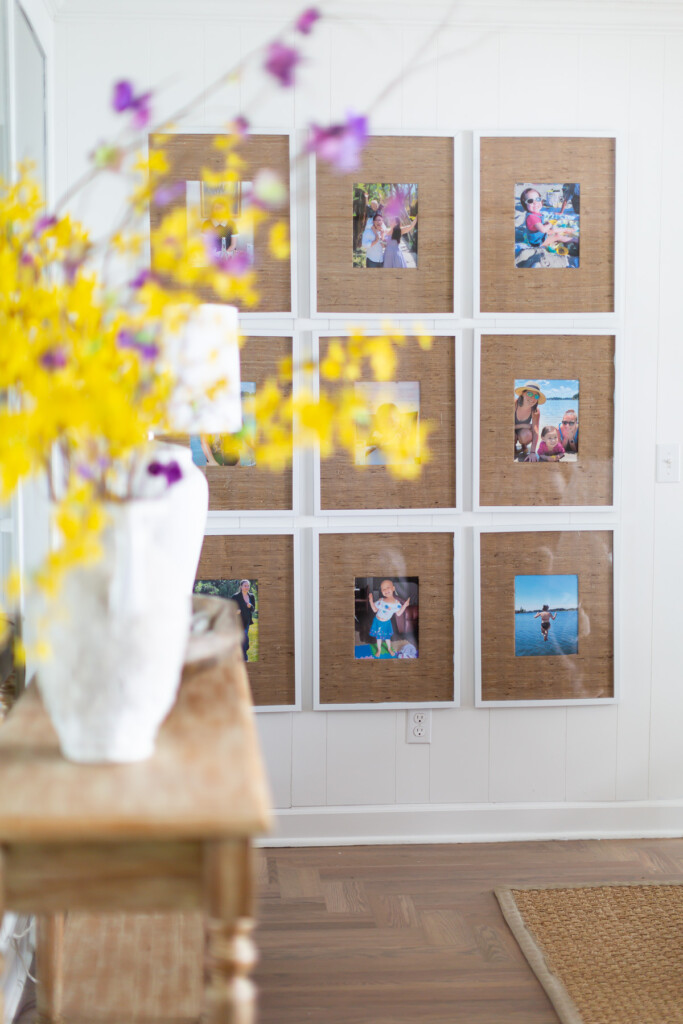 9 grid gallery wall in living room with grasscloth wallpaper remnant photo frame mats.