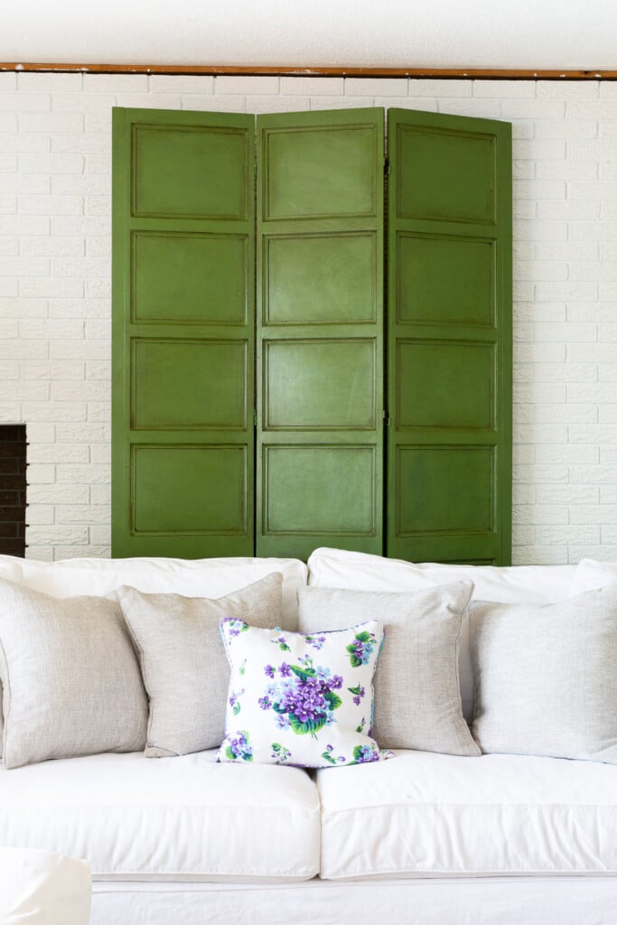 green Furniture Glaze on a decorative screen on white brick