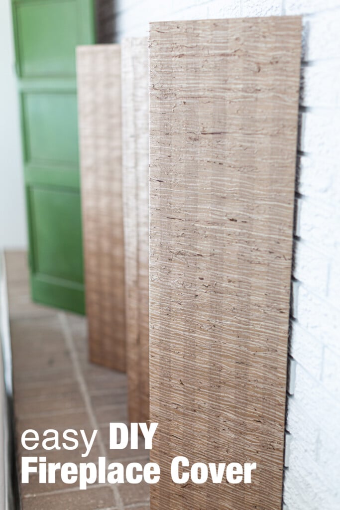 Grasscloth covered folding screen that makes an easy DIY summer fireplace cover.