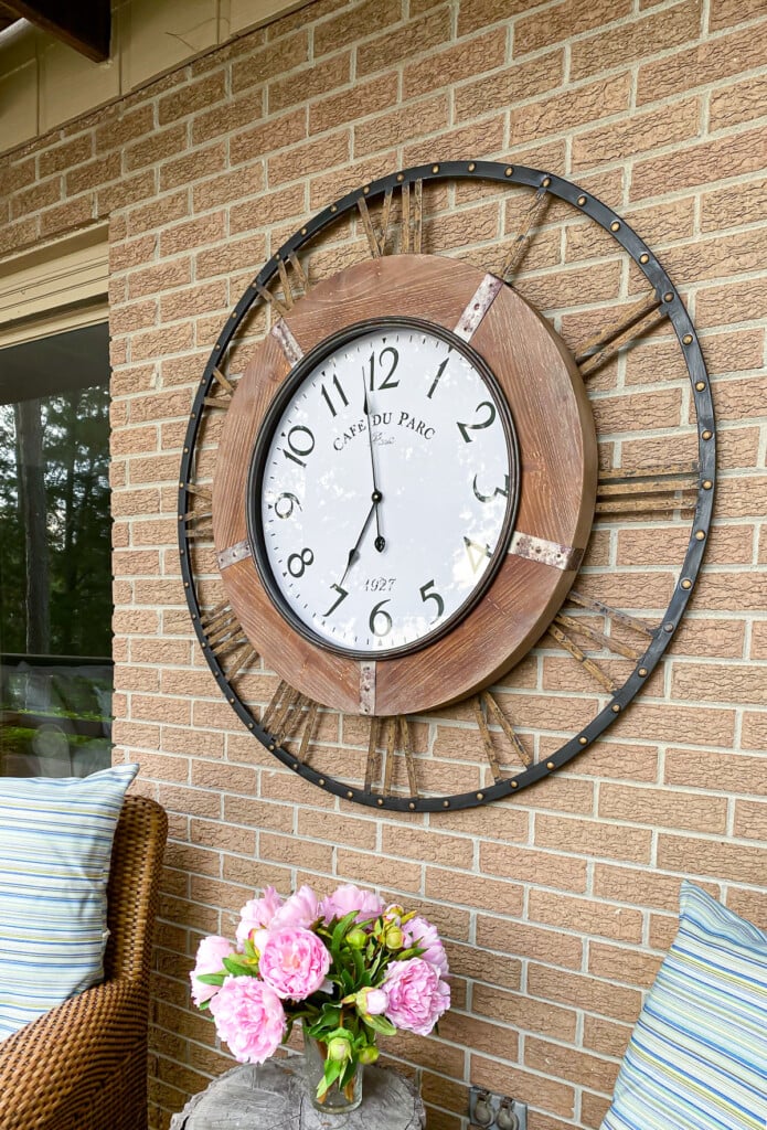 large outdoor wall clock on exterior brick wall