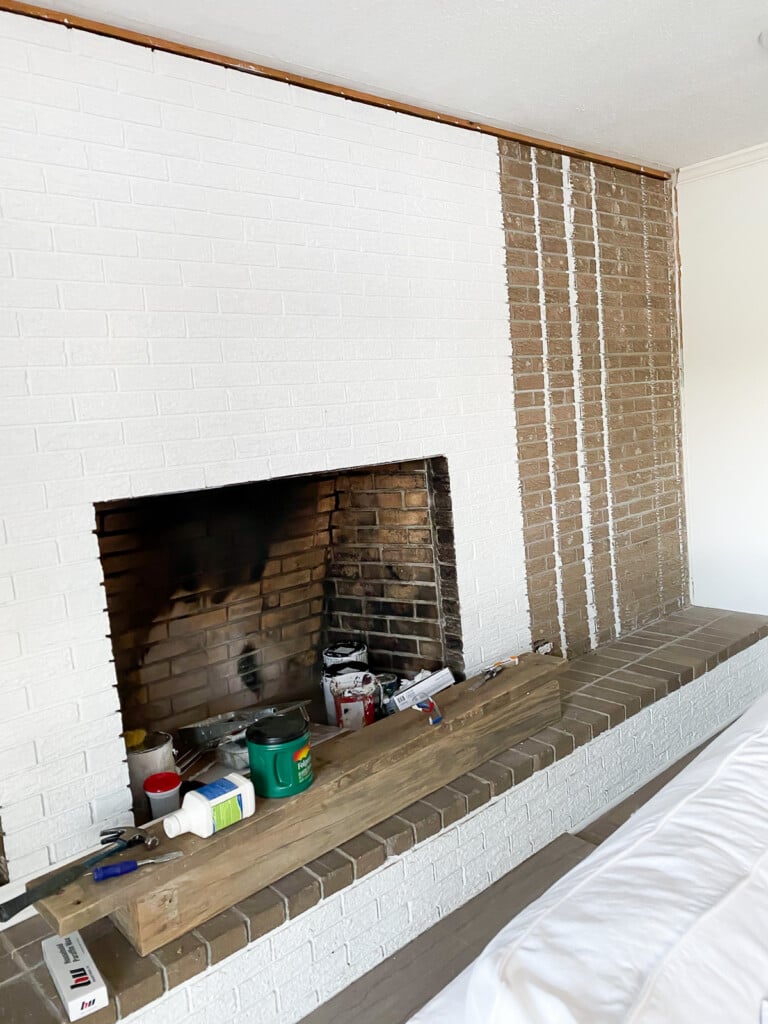 fireplace wall getting a coat of white paint