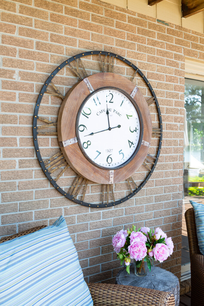 large outdoor wall clock on exterior brick wall
