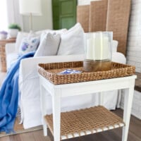 Living room with white and woven end table by sofa. Text overlay says Serena & Lily Inspired End Table Makeover