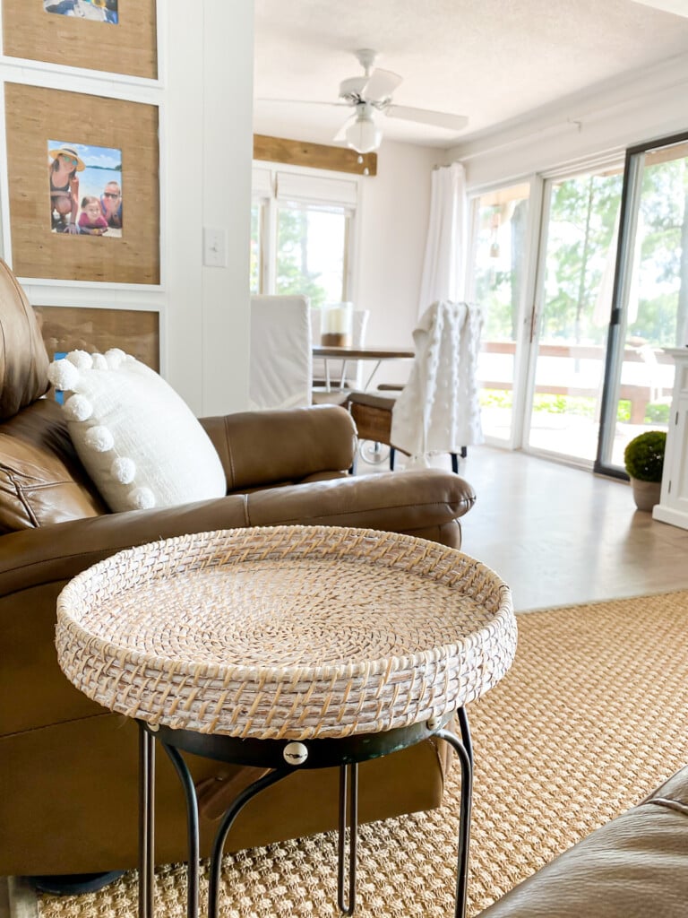 Round wicker tray topped bar stool made into a side table for a tight space.