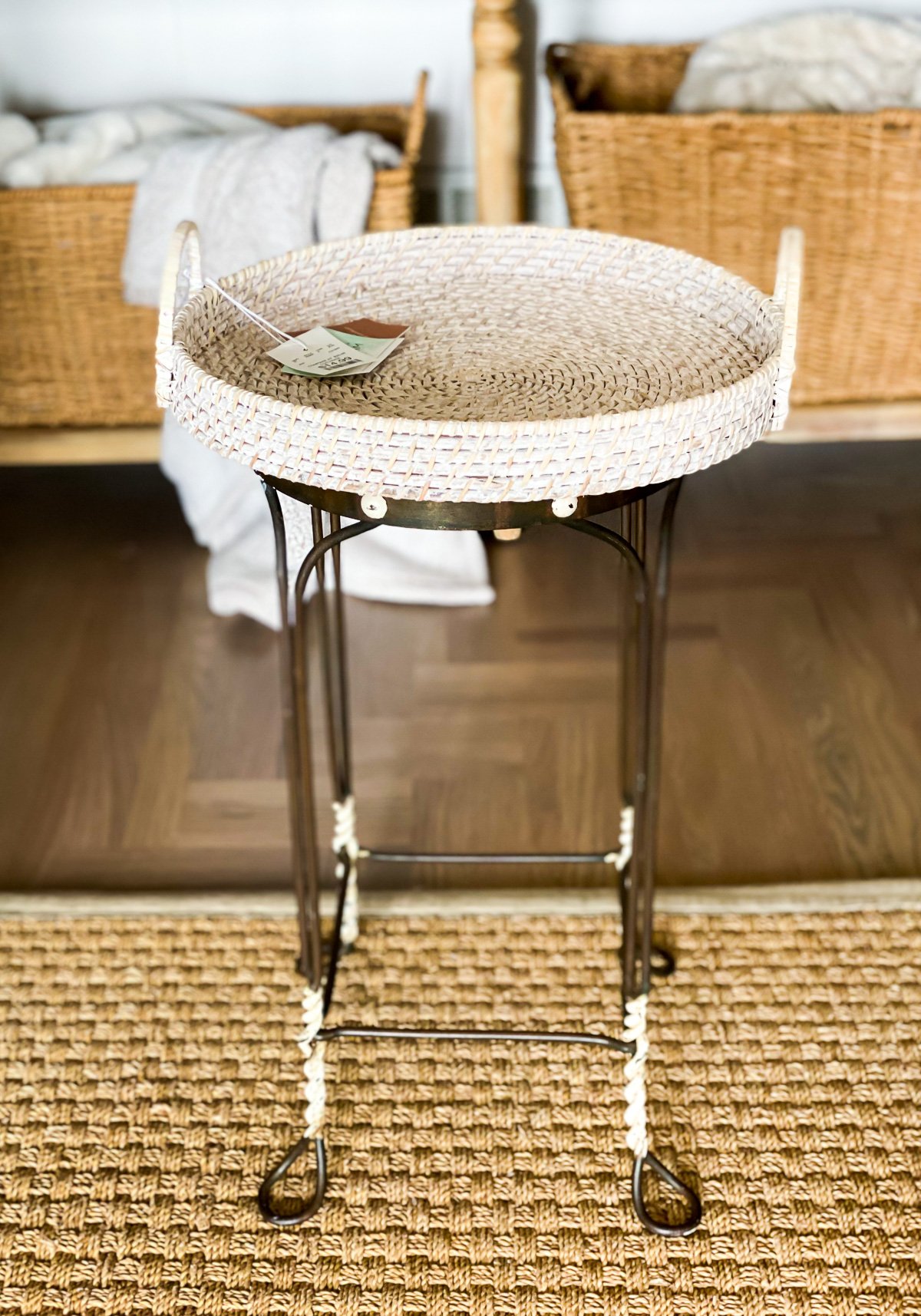 DIY side table made using a vintage metal stool and a round wicker tray.
