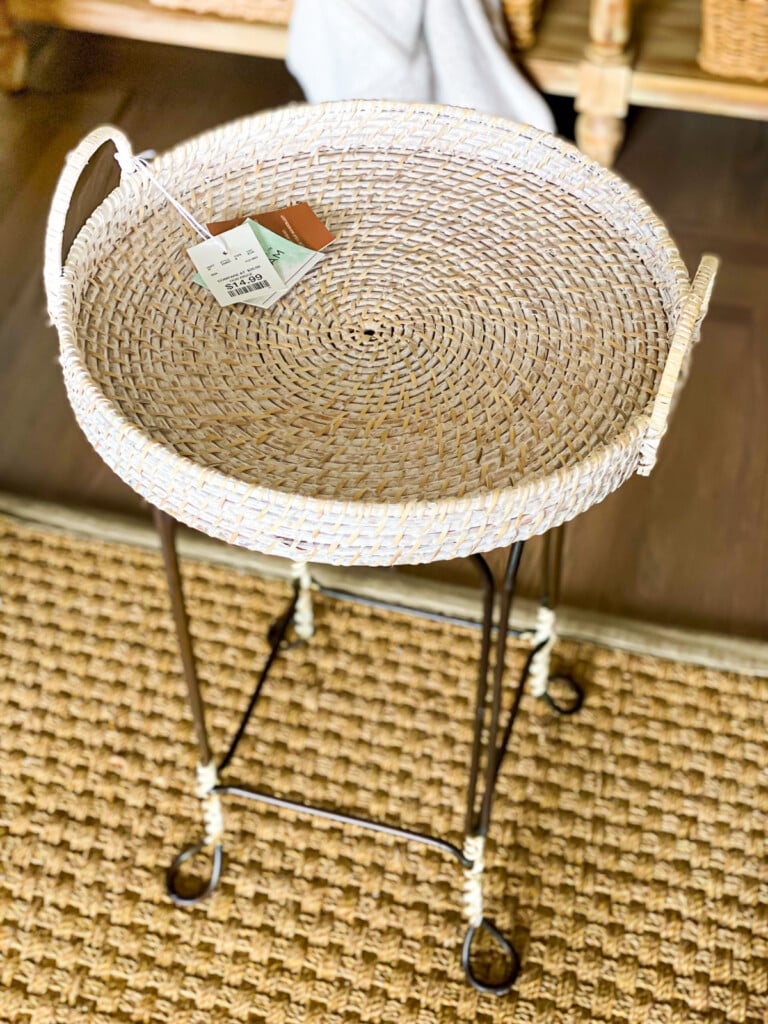 Round wicker tray with handles on a metal stool