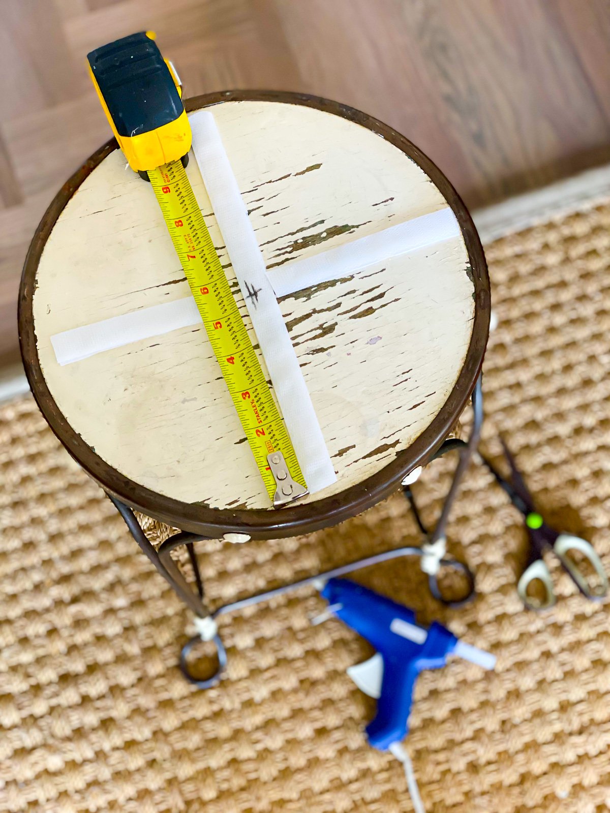 Supplies needed to attach a tray to a stool to make a unique table.