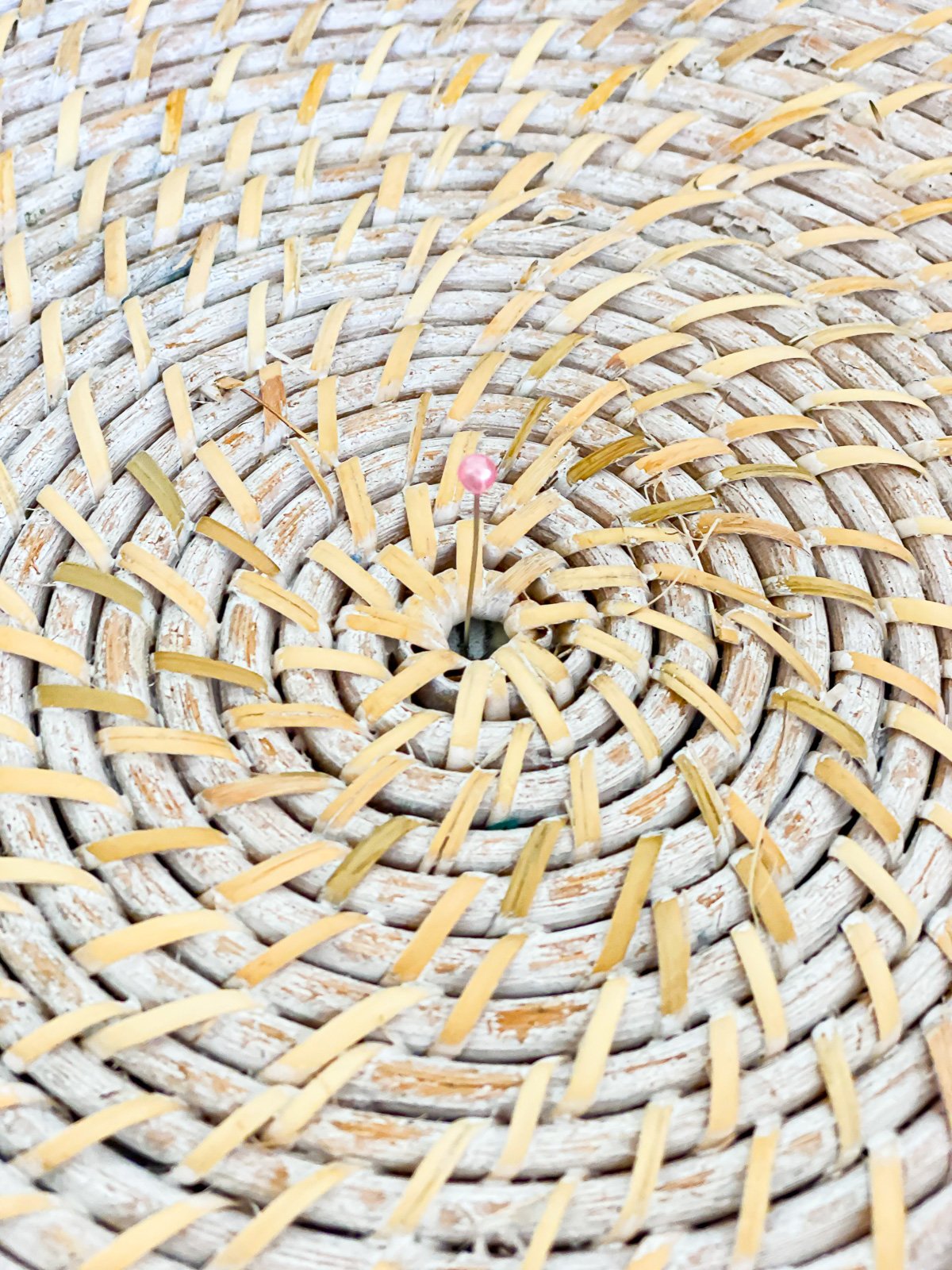 close up of center of wicker tray and a pin used to center it on stool