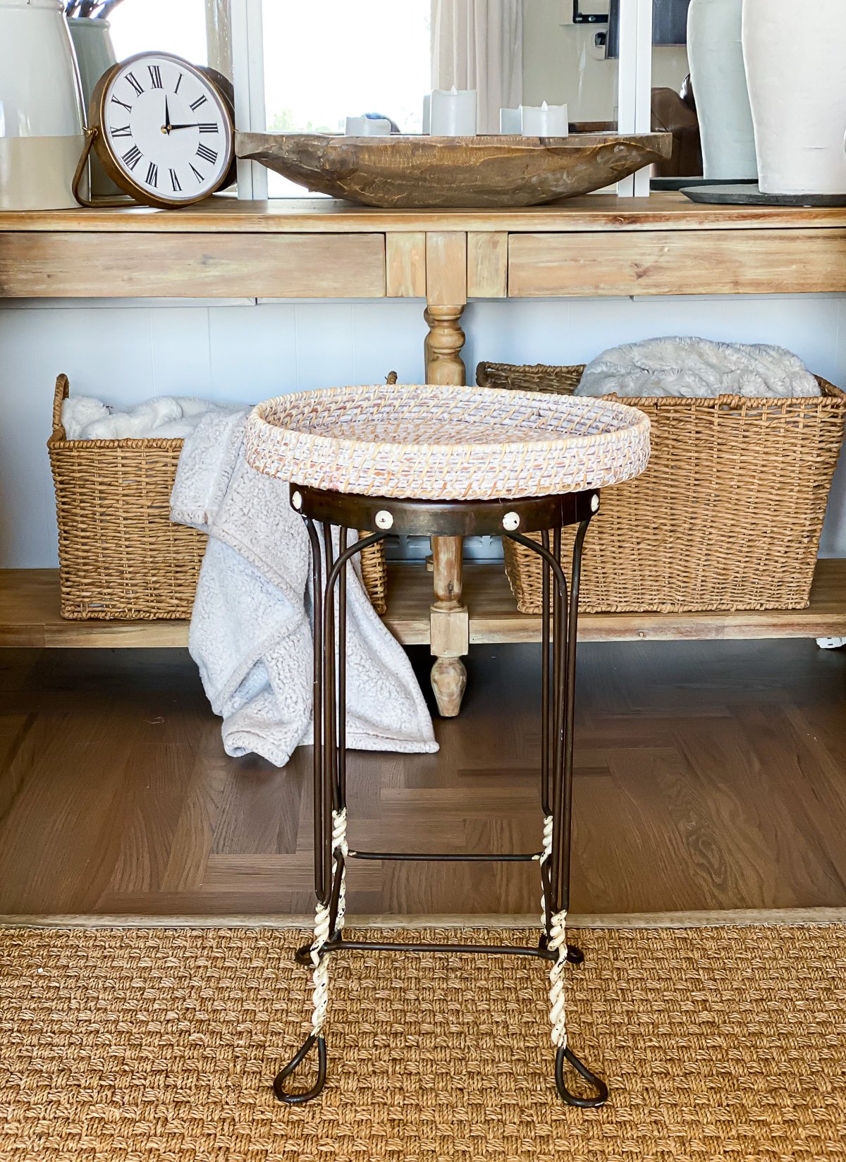 DIY side table made using a vintage metal stool and a round wicker tray.