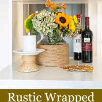 Twisted paper ribbon wrapped glass vase filled with fall flowers on kitchen counter